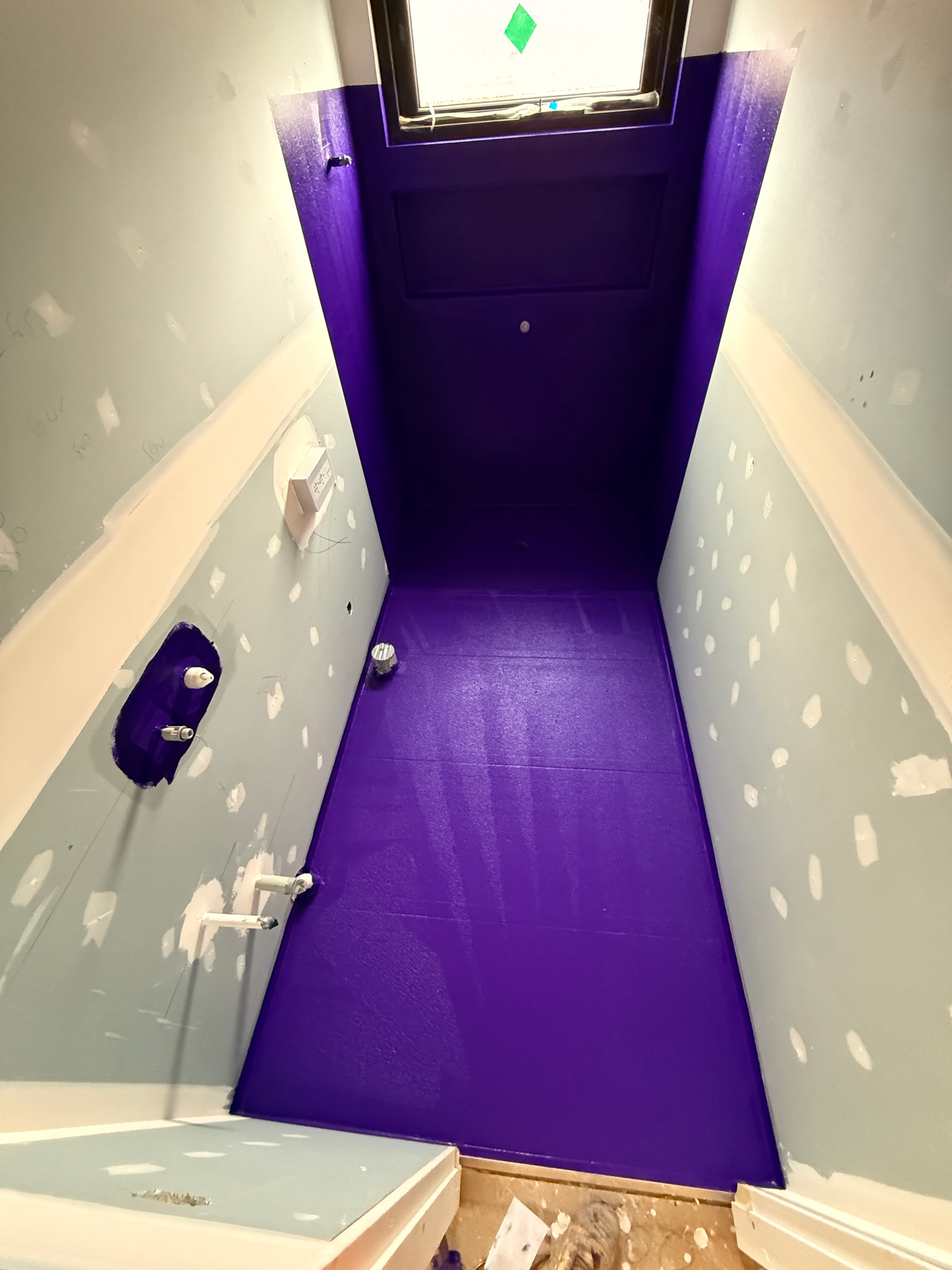 Purple waterproofing membrane applied to bathroom walls and floor — Mount Waverley job by Casey Quality Coatings
