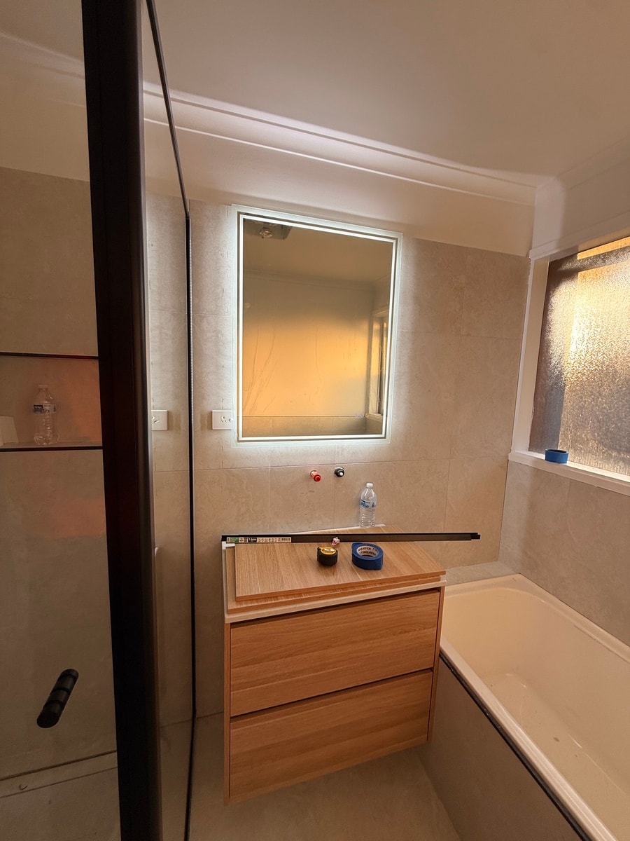 Completed bathroom renovation — modern tiled shower